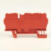 Orange plastic electrical terminal block with multiple slots and mounting clip, viewed from the side.
