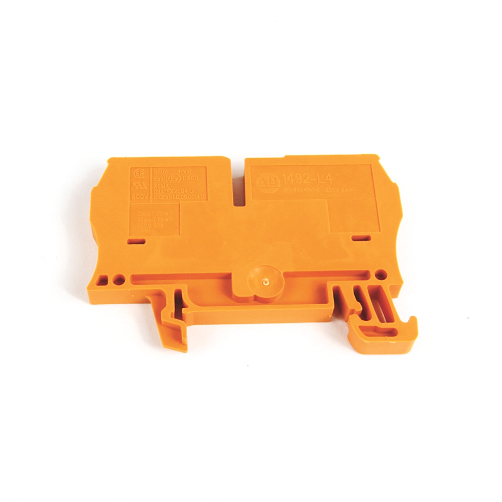 Orange plastic terminal block housing with mounting ears for wiring in an electrical/control panel.