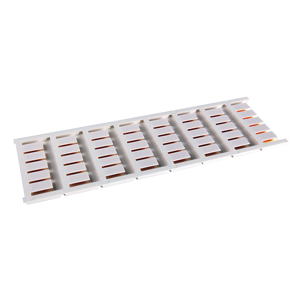 White plastic slotted tray with many evenly spaced rectangular slots, viewed at an angle.