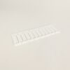 White plastic panel with multiple evenly spaced rectangular slots laid flat on a light background.