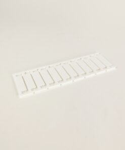 White plastic panel with multiple evenly spaced rectangular slots laid flat on a light background.