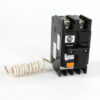 AB-brand circuit breaker with orange Test button and a white coiled lead attached to the side.