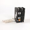 Black A-B circuit breaker with orange TEST button and coiled white cord attached on left side, isolated on white background, informative image of electrical device.