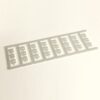 Gray plastic sprue with eight identical rectangular frames containing small cross-shaped cutouts.