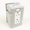 Grey electrical transformer with a recessed front outlet and three terminal posts on top
