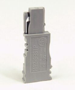 Gray modular electrical connector module standing upright on a white background, side view showing a locking mechanism on top edge and labeling on the front.
