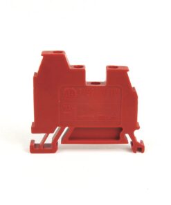 Red modular electrical terminal block with mounting feet, viewed from the side.