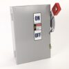 Gray metal electrical enclosure with a red vertical toggle switch labeled ON/OFF and warning sticker.
