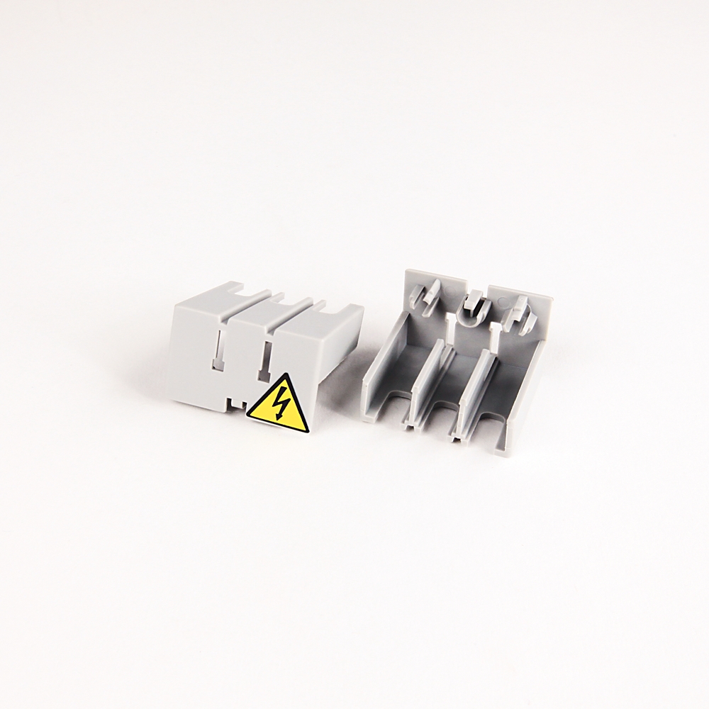 Gray modular electrical terminal blocks with a yellow high-voltage warning sign on a white background.