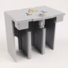 Grey plastic electrical terminal block with three vertical slots and a caution label on top in a small enclosure.
