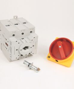 Three‑pole industrial circuit breaker with a red rotary handle on a yellow base and a metal mounting bolt in front.